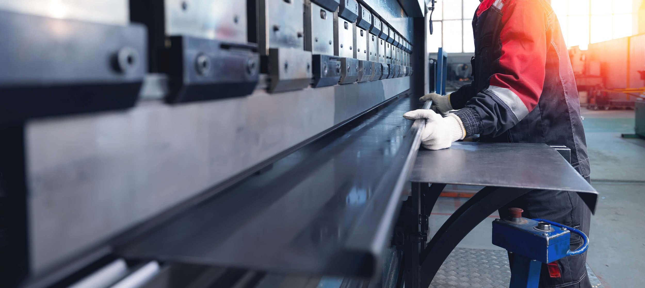 Midcoast Metal male worker operating industrial metal press brake
