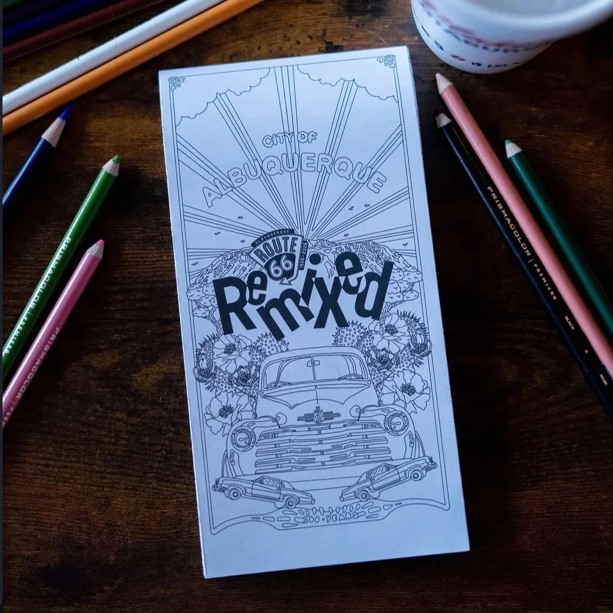 Coloring page featuring an illustration of a vintage car, flowers, and the Route 66 shield, with the text 'Albuquerque' and 'Depew Mixed' and scenic mountain background.