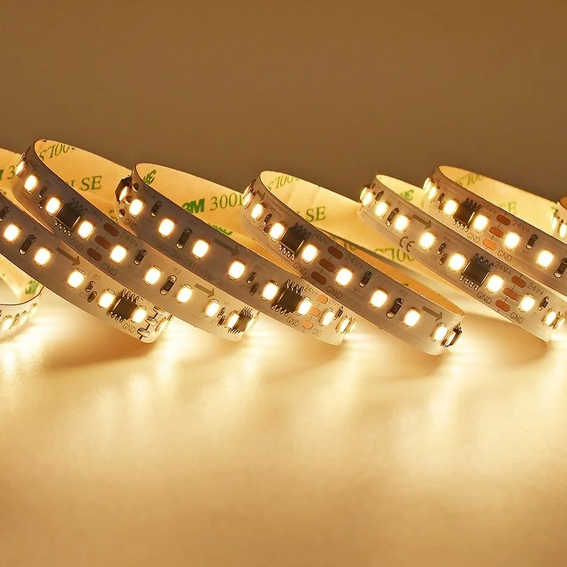 Close-up of LED strip lights emitting bright white light, curved on a flat surface.