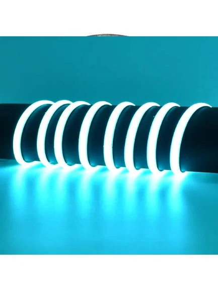 Neon light installation with glowing, curved white tubes on a dark background, casting blue light onto surface.