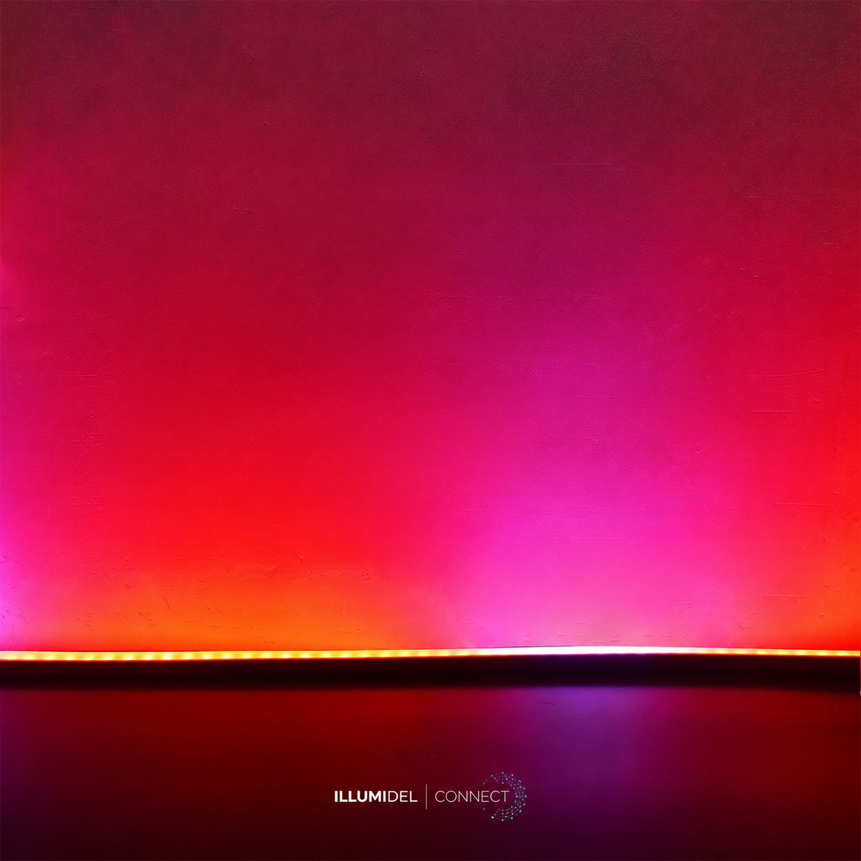 A wall illuminated with gradient pink, purple, and orange LED lights, with a strip of orange and amber LED lights at the bottom and the words 'ILLUMIDEL CONNECT' at the bottom center.