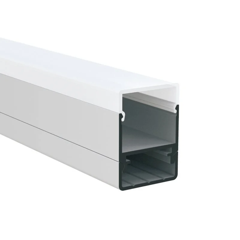 Close-up of a white aluminum extrusion with hollow rectangular interior and ridges at the bottom.