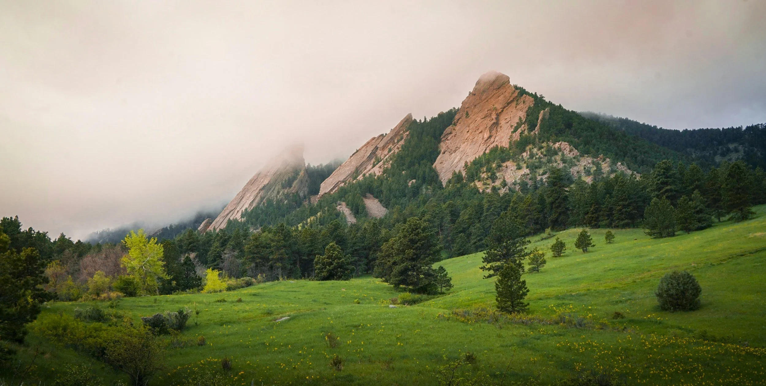 Boulder's Flatirons under a fog