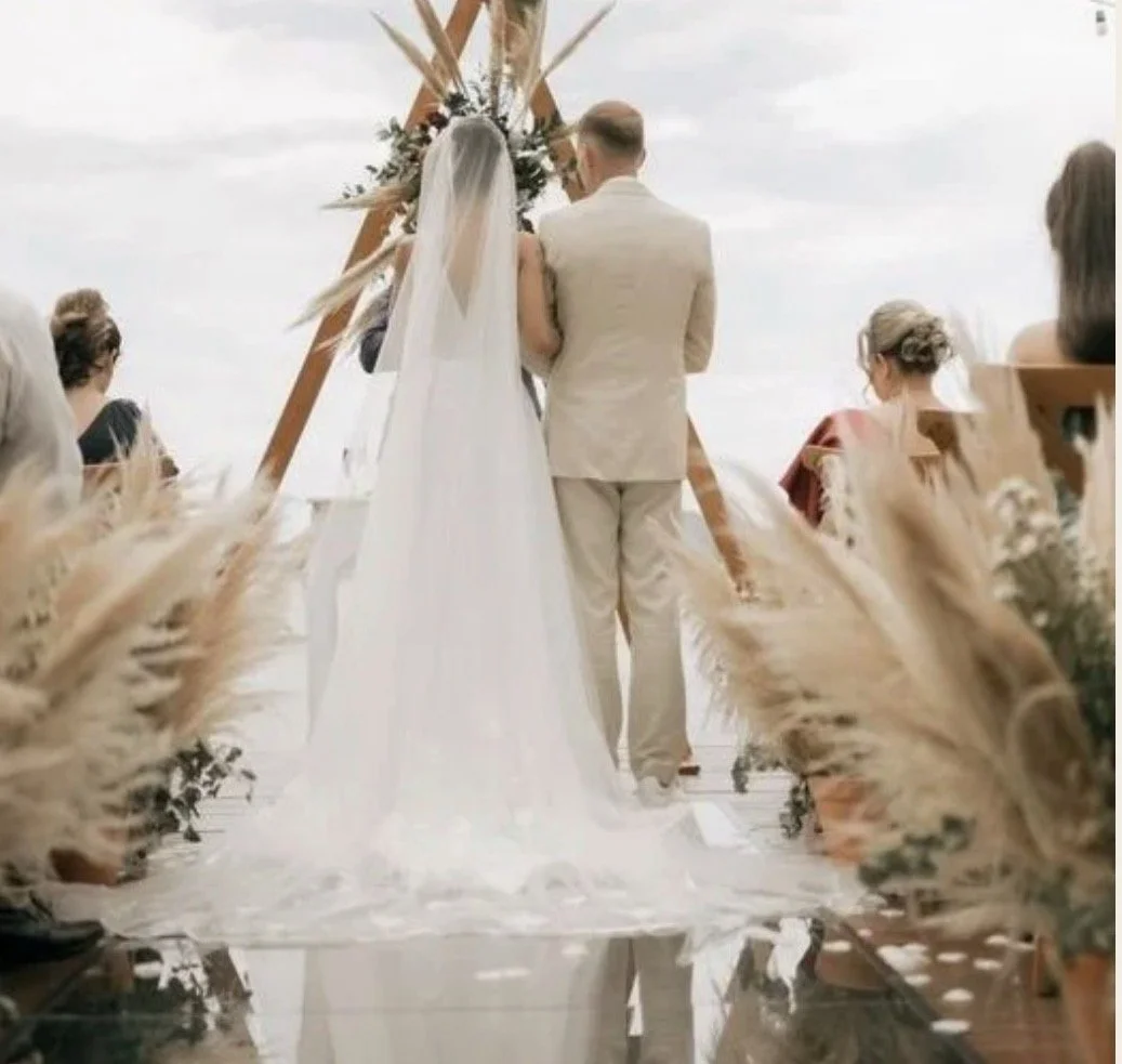 A bride and groom walking together during a simple ceremony