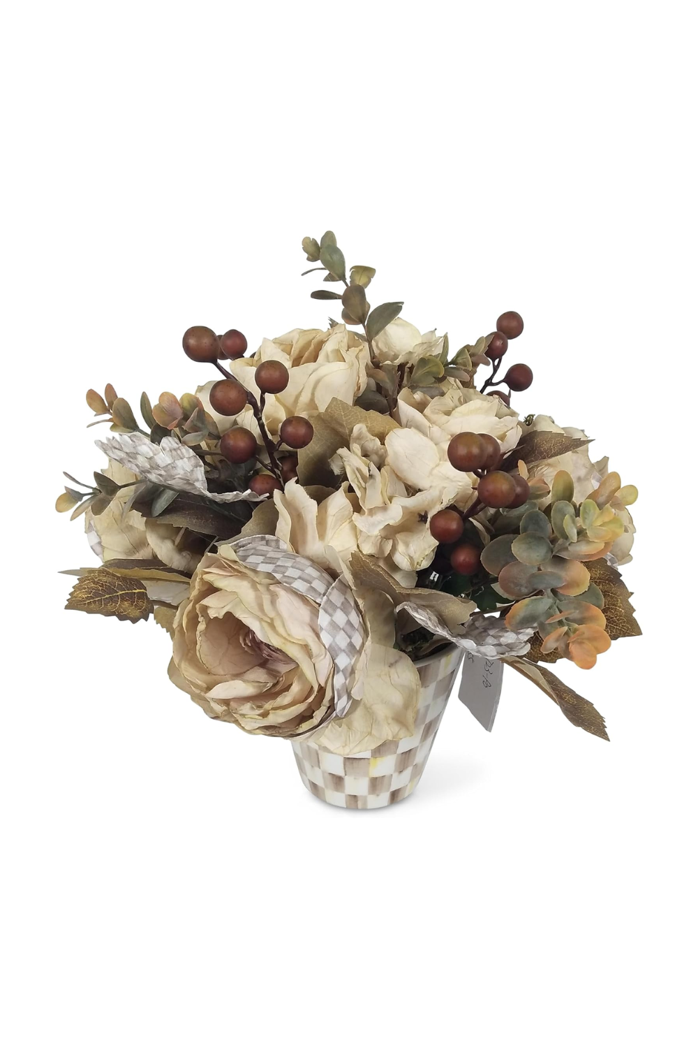 A decorative artificial flower arrangement in a checkered white and beige ceramic pot, featuring cream-colored roses, green foliage, and brown berries.