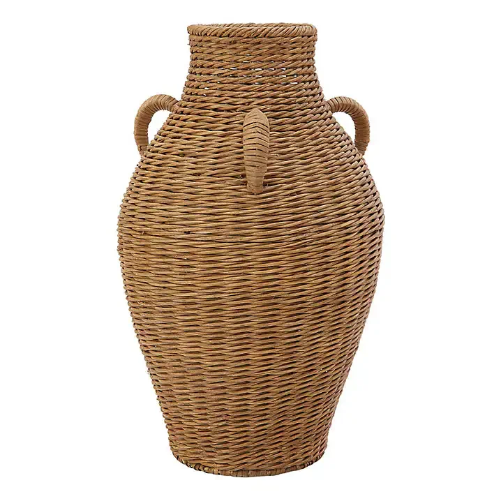 A tall woven basket with an elephant design, including an elephant's trunk and ears, and two small handles on the sides.