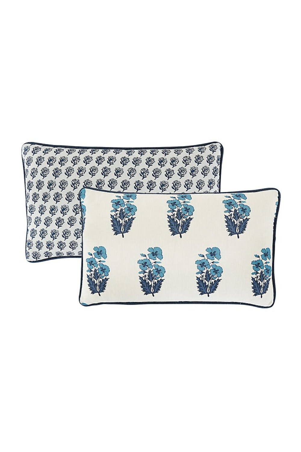 Two decorative throw pillows with blue floral and leafy patterns on a white background, bordered with navy piping.