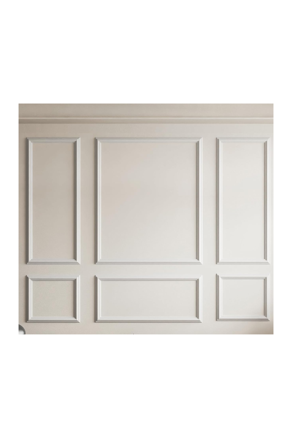 Close-up view of a beige wall with decorative white rectangular panel molding accents.