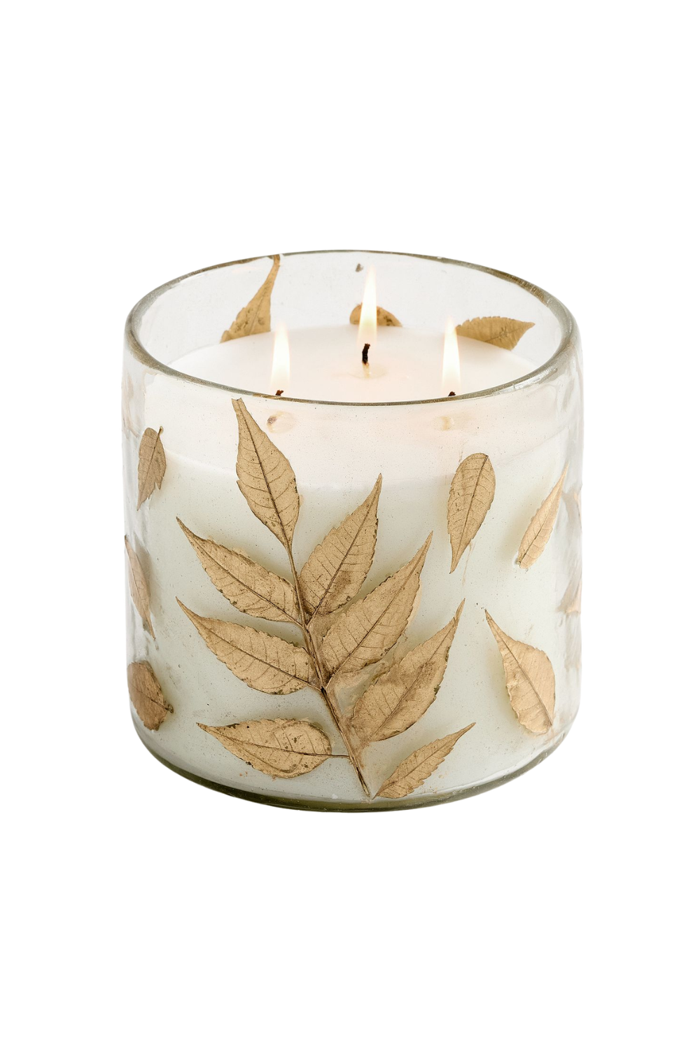 A white candle with three flames in a glass holder decorated with dried leaves.