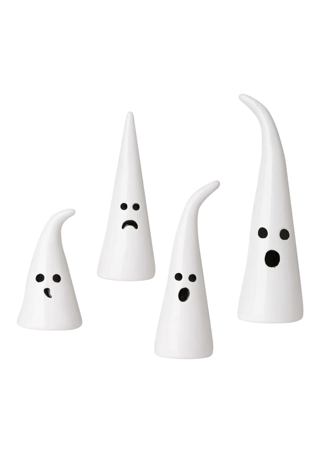Set of four white ceramic ghost figurines with black facial features, varying in size, on a white background.