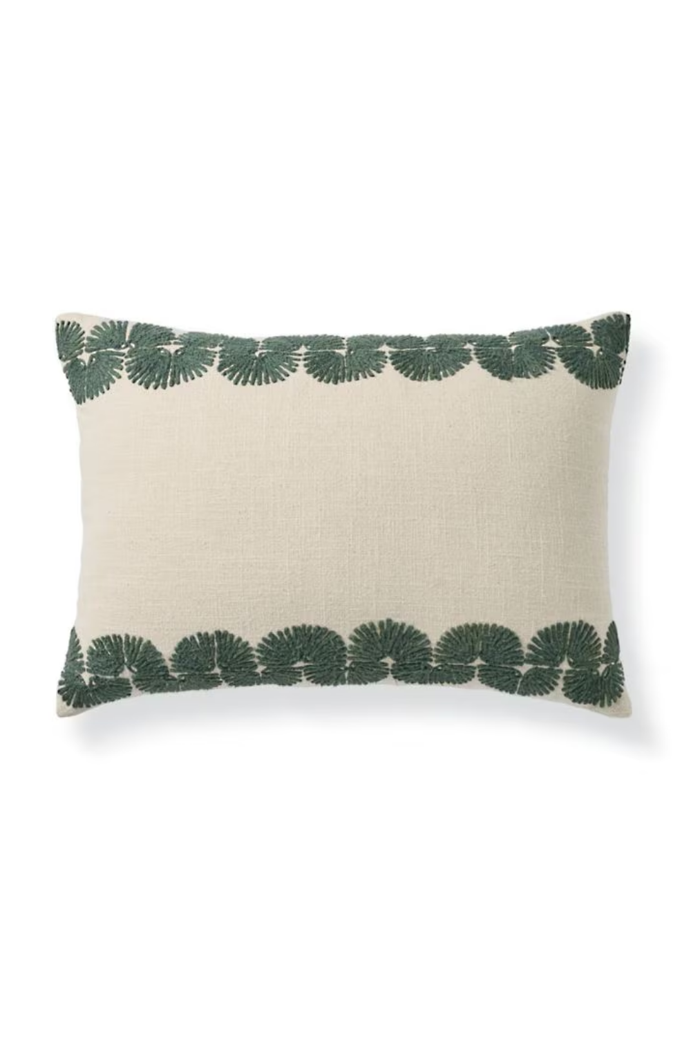Cream-colored rectangular pillow with green leaf pattern border