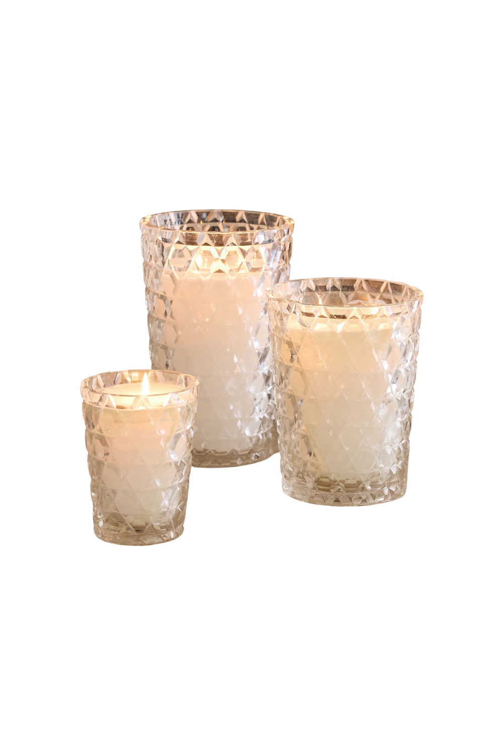 Three lit candles in textured glass holders of different sizes, with a white background.