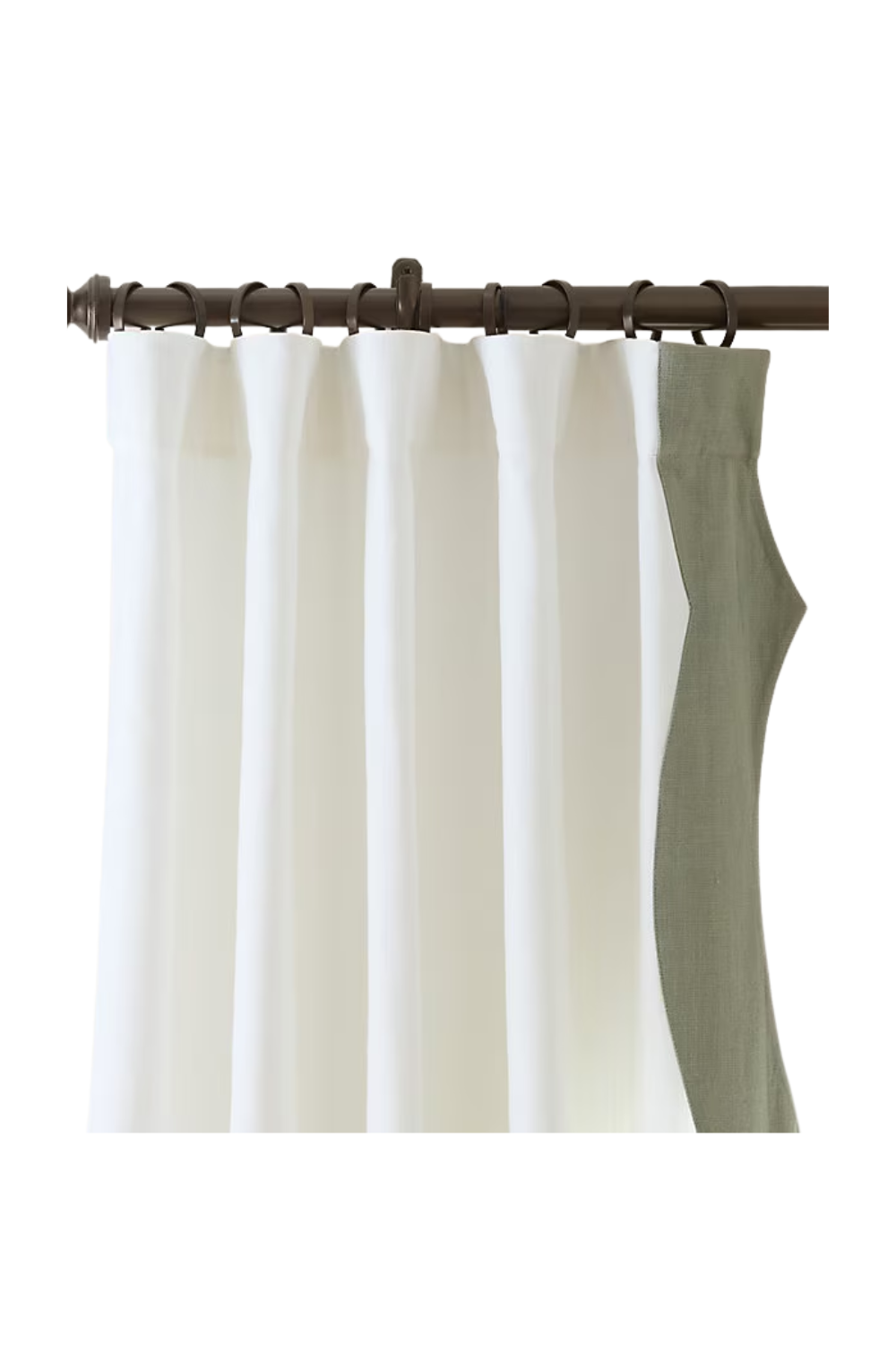 White and beige curtains hanging on a brown curtain rod with rings.