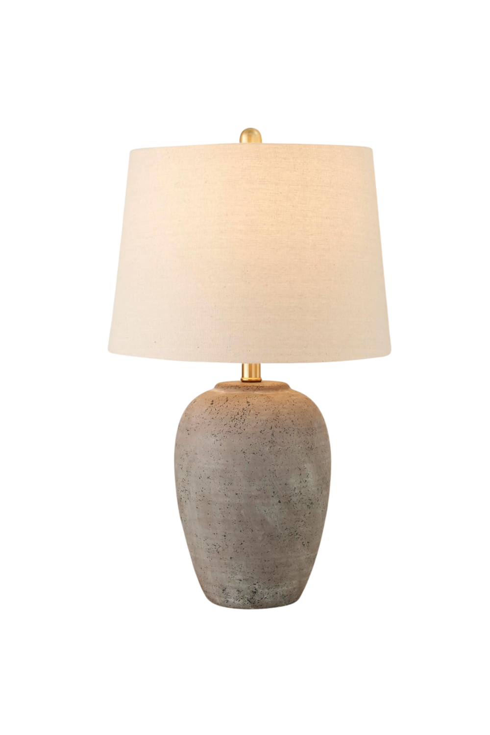 A table lamp with a textured, stone-like base and a large beige lampshade.