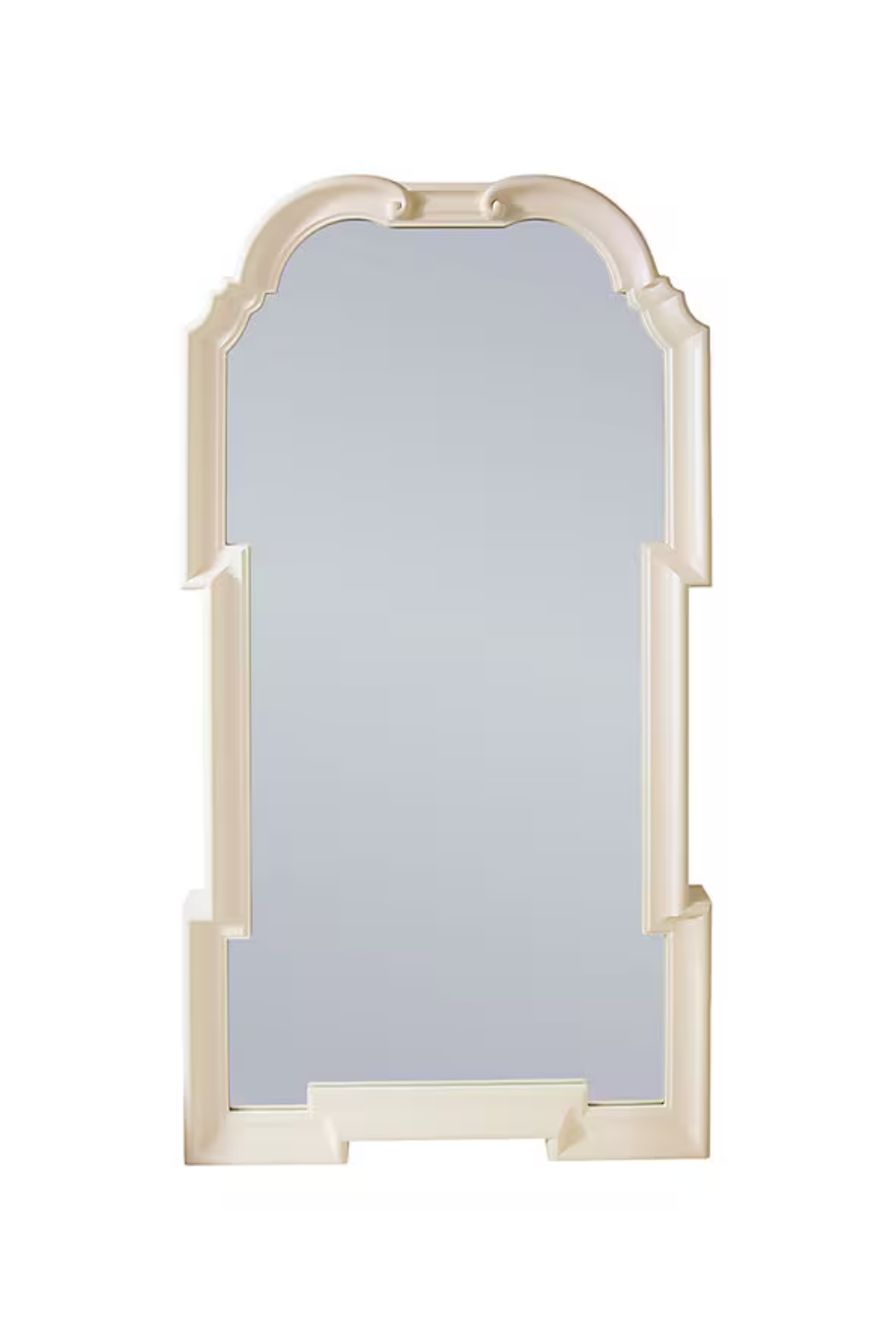 A freestanding mirror with an ornate, beige-colored frame and a rectangular shape topped with rounded curves.
