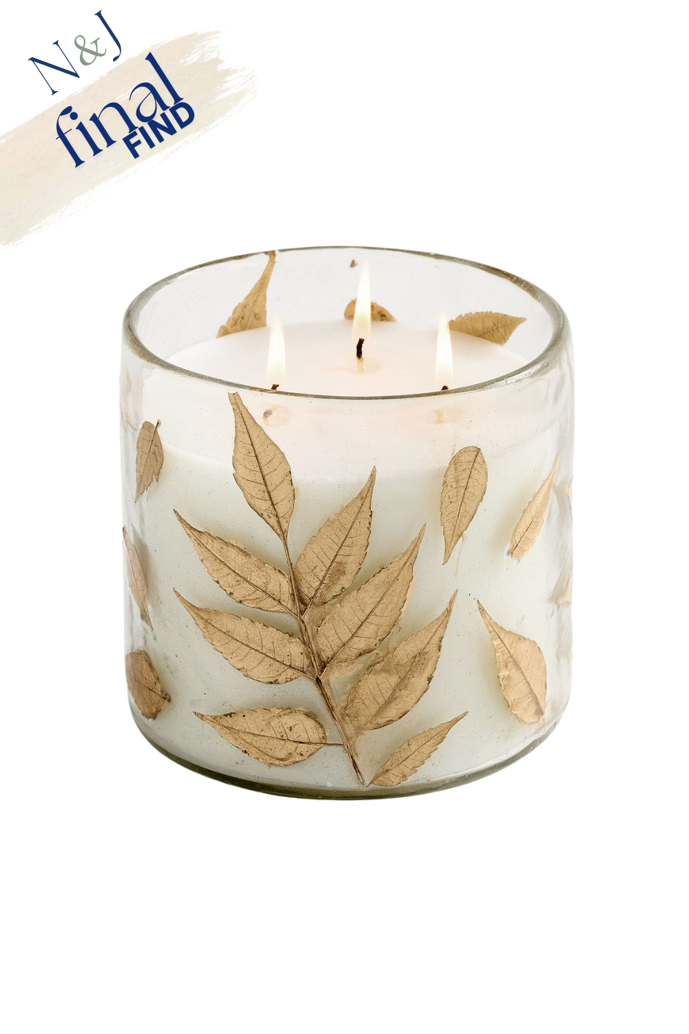 A glass candle holder decorated with dried leaves and containing a white candle with three wicks.