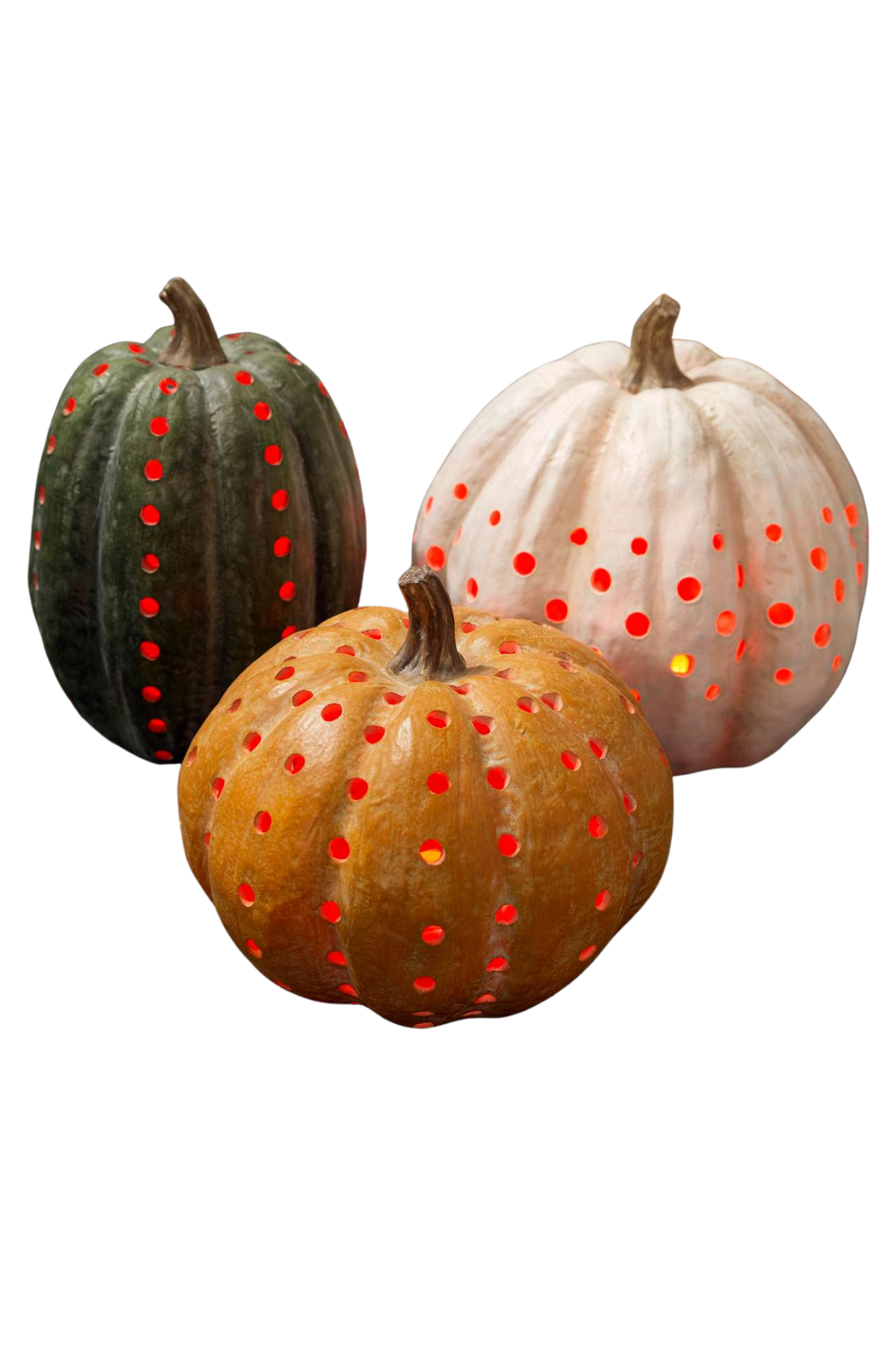 Three pumpkins with holes and red lights inside, resembling Halloween decorations.