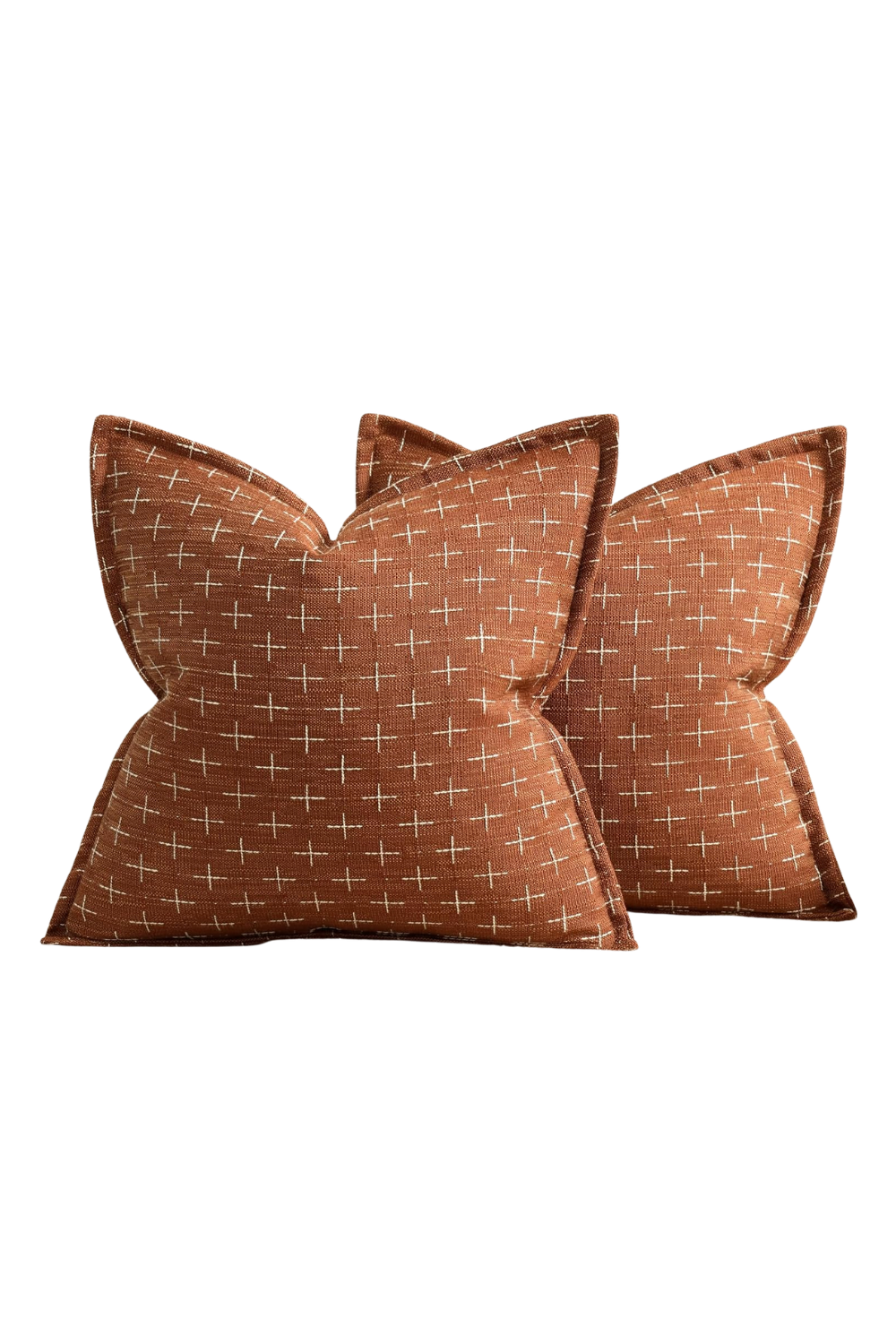 Two brown decorative pillows with white cross pattern on a white background.