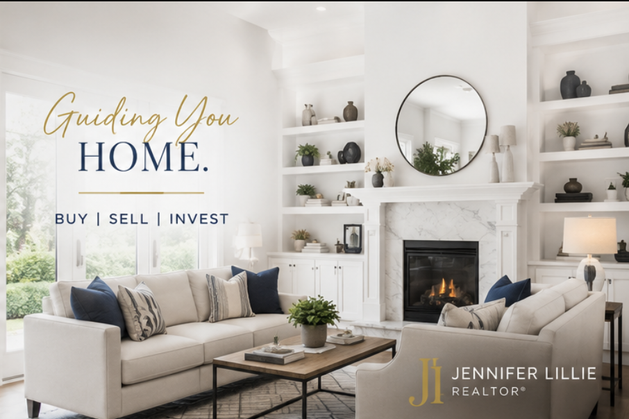 Living room with white sofas, a marble fireplace, built-in bookshelves with decorative items, a round mirror, and large windows letting in natural light, promoting home buying, selling, and investing.
