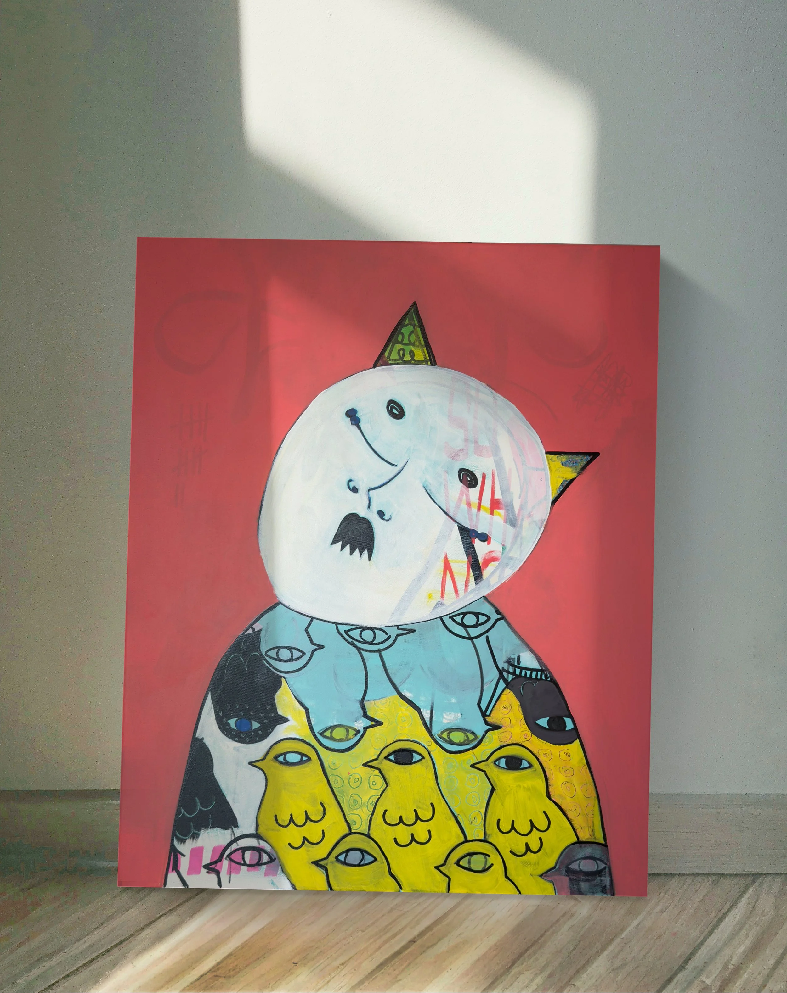 A multi-colored artwork with a pink background featuring a large cat with a unicorn horn and multiple eyes on its body, created with bold lines and bright colors. The artwork is displayed against a plain wall.