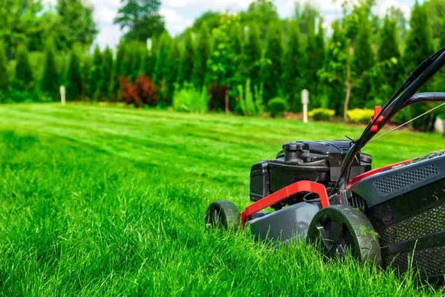 walk-behind mower cutting grass for residential lawn service