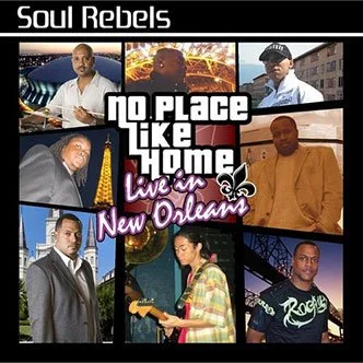 Collage of seven people, some holding musical instruments, with a central text that reads 'No Place Like Home' and 'Live in New Orleans,' and the title 'Soul Rebels' at the top.