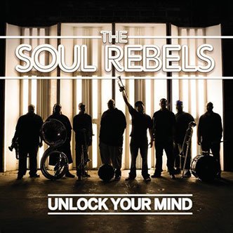 Silhouettes of six band members standing in front of a lit curtain, with the text 'The Soul Rebels' and 'Unlock Your Mind' overlaid.