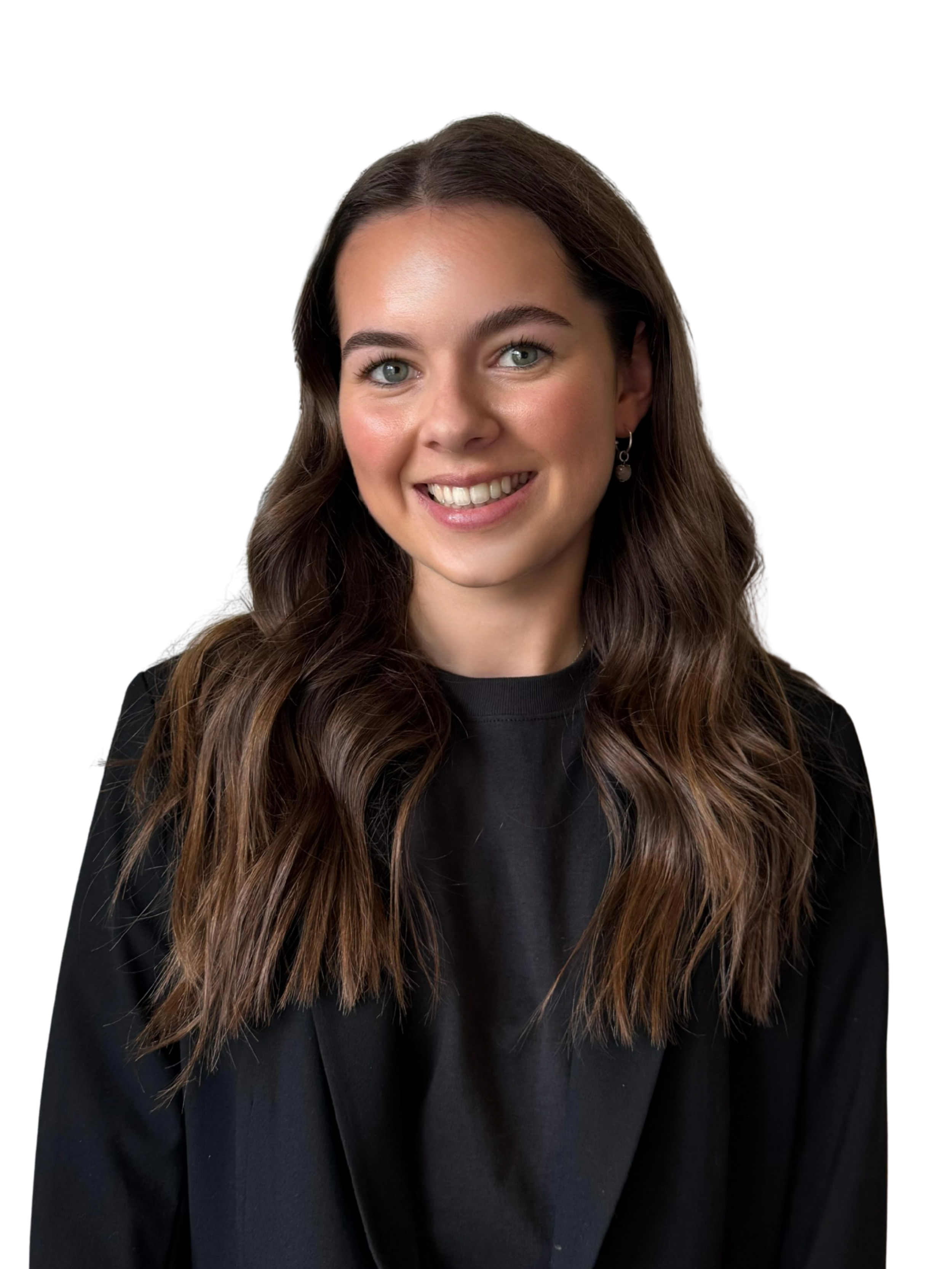A young woman with long wavy brown hair and wearing a black top and earrings, smiling at the camera, against a white background.