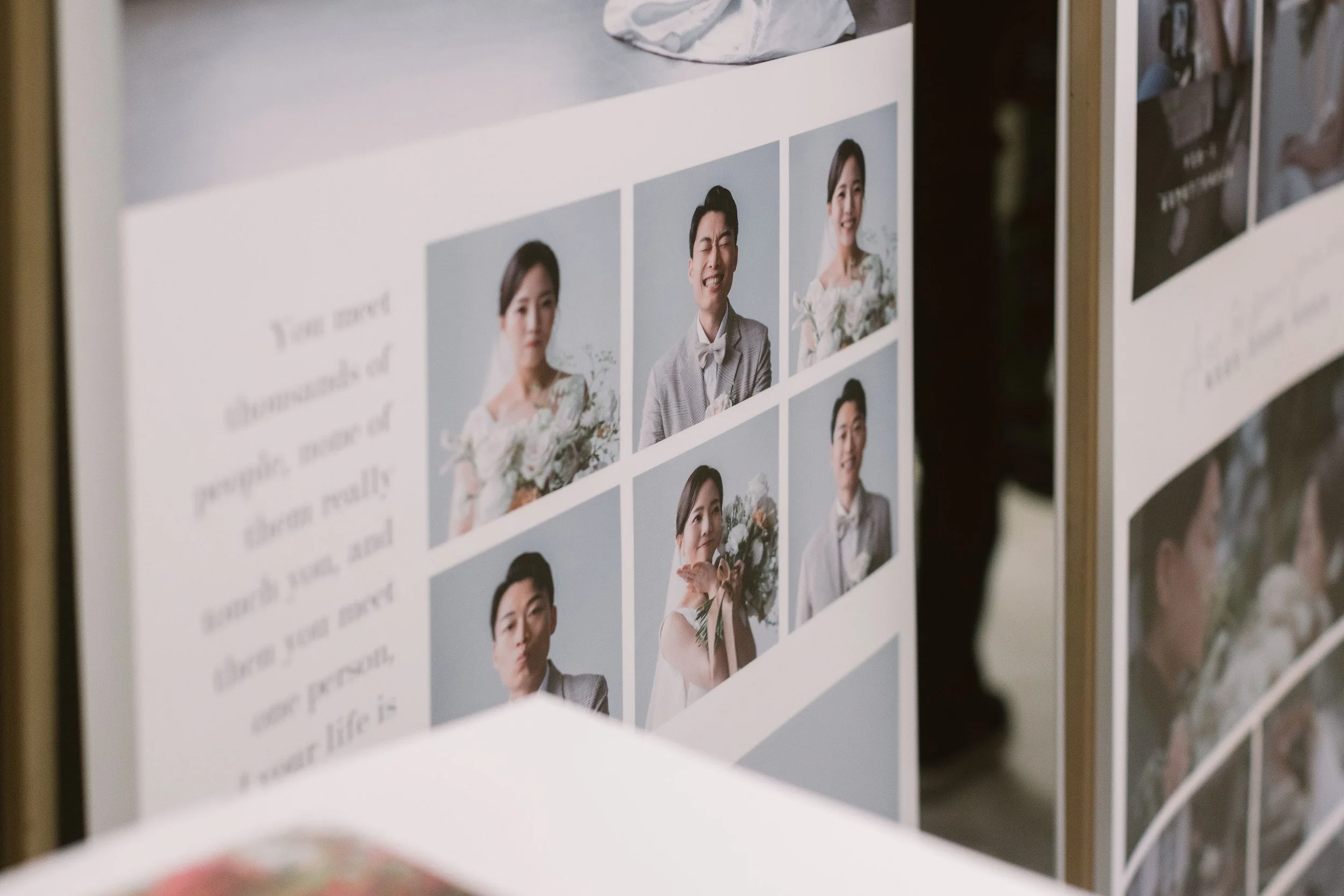 Close-up of a photo display board with multiple portrait photos of people, including a woman holding a bouquet and a man in a suit, with some text partially visible on the left side.