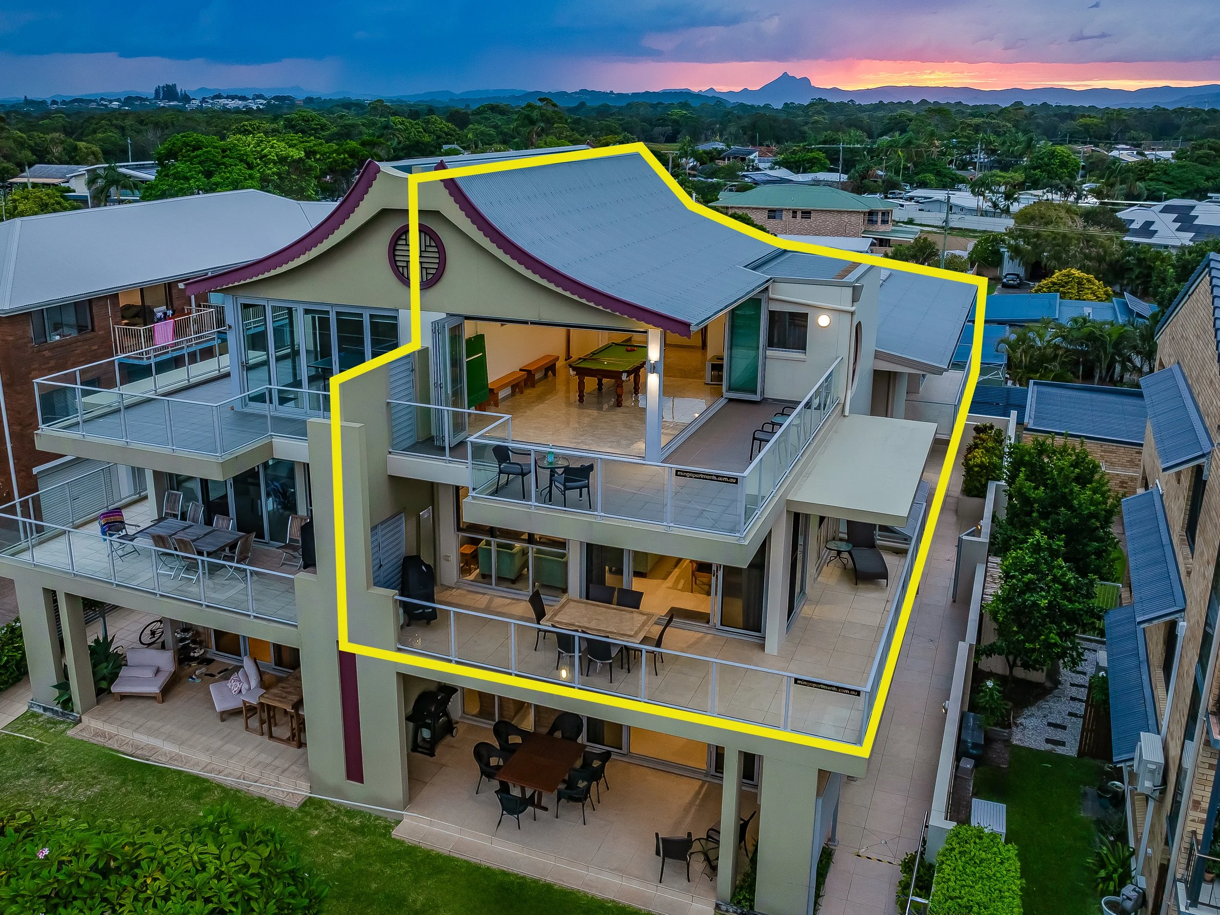 Elevated view of MING 3 Beachfront on Marine Parade showing wrap-around balconies and rooftop entertainment area opposite Kingscliff Beach.