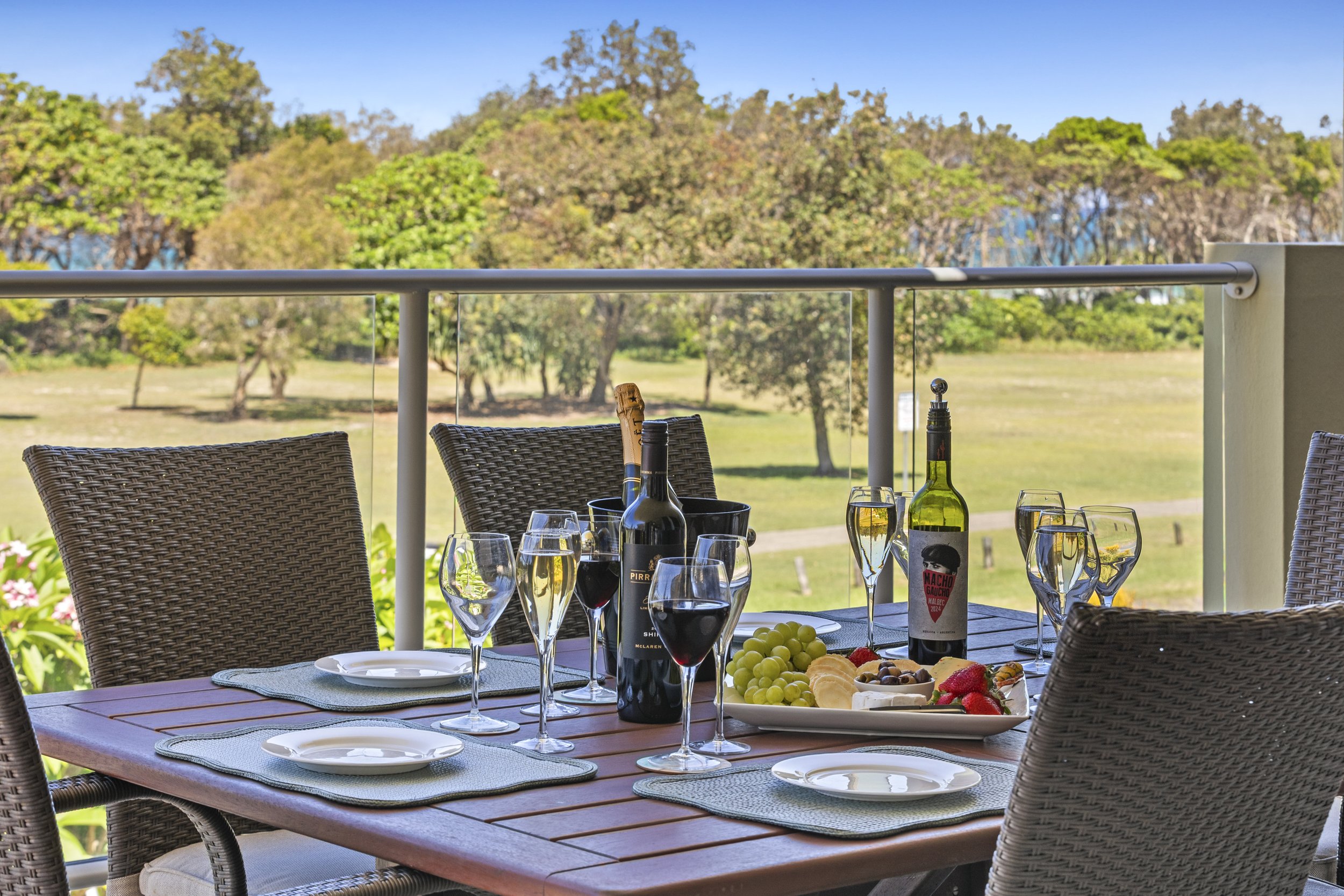 Outdoor dining table set for a shared meal on the balcony at MING 3 in Kingscliff.