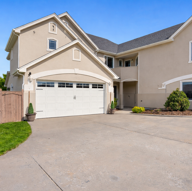 street-facing carriage house garage doors with stamped steel panels