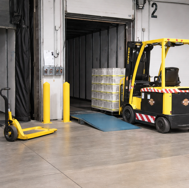 forklift driver ducking under closing dock door