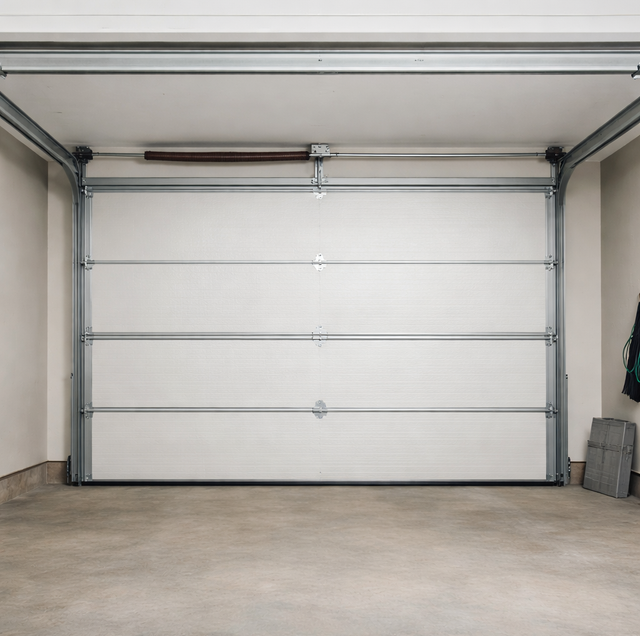 sunlit garage door pocked with hail dents