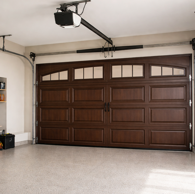 suburban house with new wood garage door and car parked outside