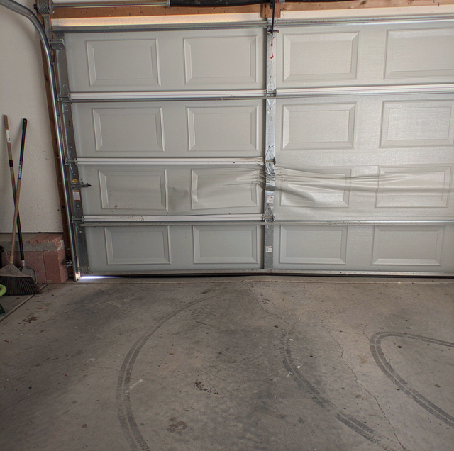 car crease dent on residential garage door panel