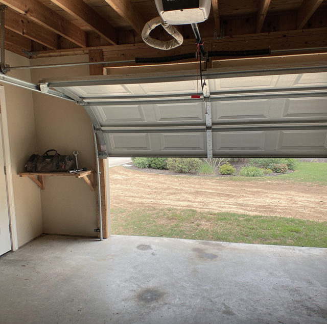 rusted garage door torsion spring and opener unit