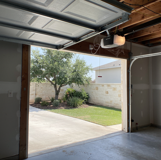 garage door stuck fully open beneath steel track