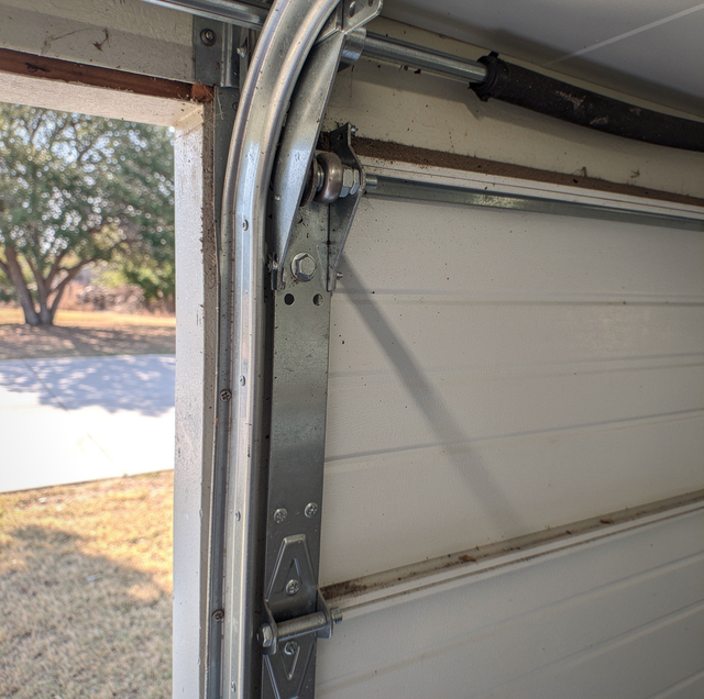 garage door top bracket torn steel bent roller track