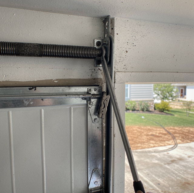 Broken torsion spring above residential garage door