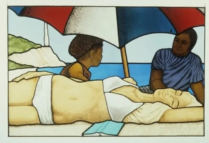 A beach scene with two children, one lying on a bed under a large red, white, and blue umbrella, and the other sitting next to them. There is water and land in the background.