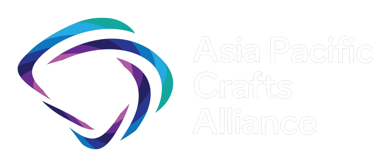 Logo of the Asia Pacific Crafts Alliance featuring a stylized, colorful gem shape next to the organization's name
