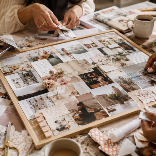 Groupe de personnes créant un collage avec des photos et des souvenirs sur une planche en bois, entourées de magazines, photos, fleurs artificielles, rubans et tasses de café lors d'un brunch atelier Maison Tourterelle