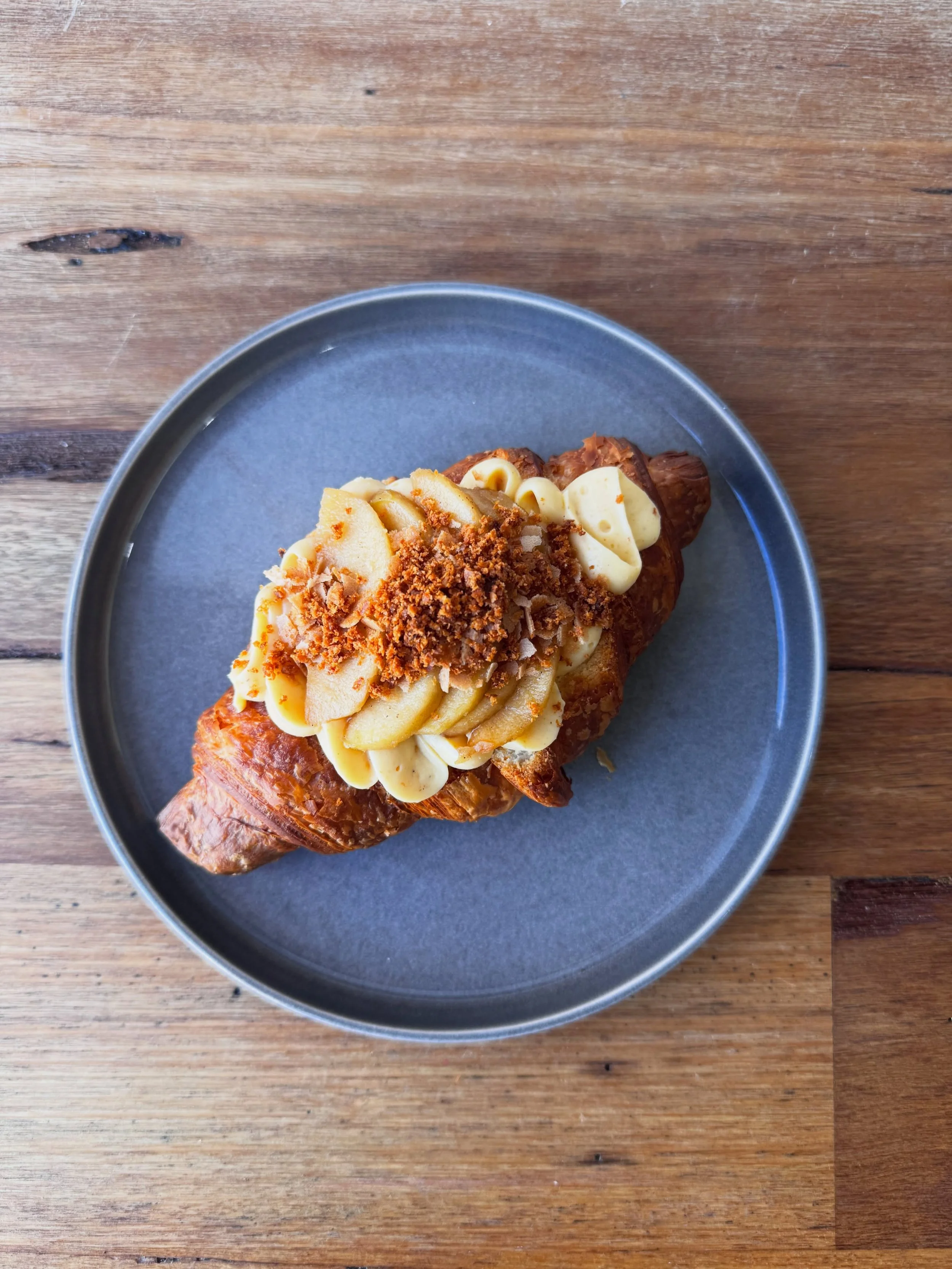 Poached and sliced apple with burnt butter custard and crispy croissant