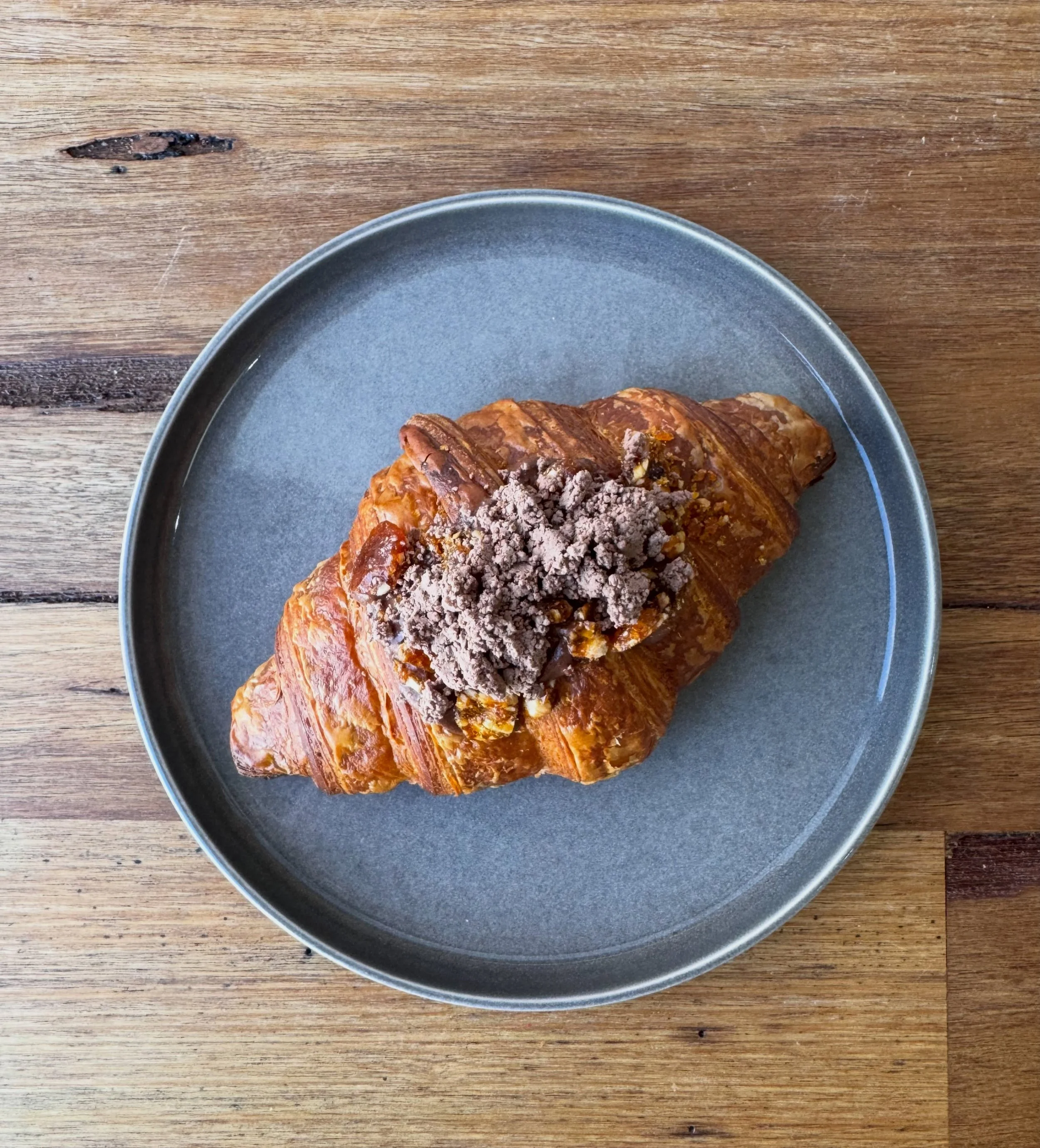 Chocolate hazelnut filled croissant with a hazelnut praline with Nutella chocolate soil