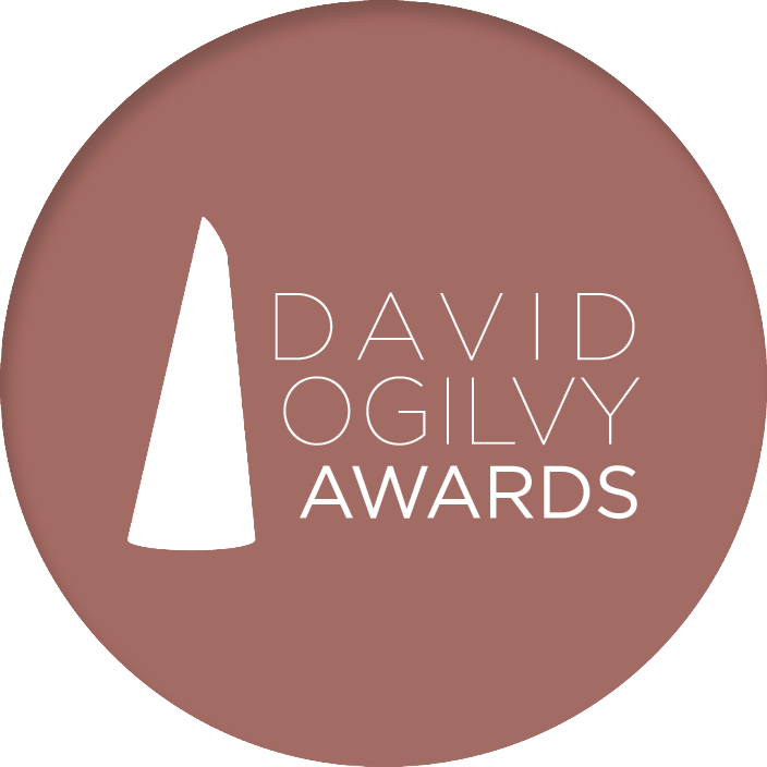 Logo for the David O'Gilly Awards featuring stylized black trophy silhouette on a muted pink circular background with the text 'David O'Gilly Awards' in white.