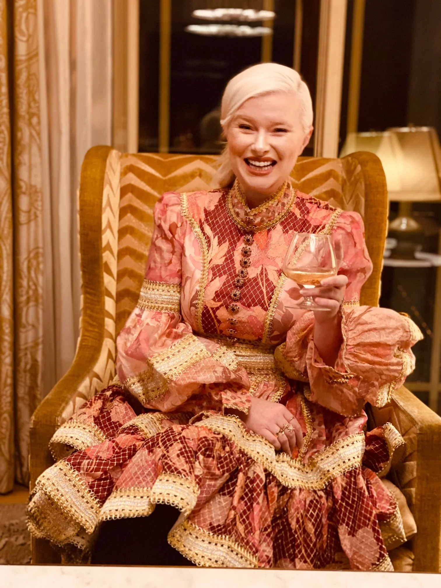 Alternate professional profile portrait of advertising creative director Kate Catalinac on chair in Dorchester Hotel suite London.