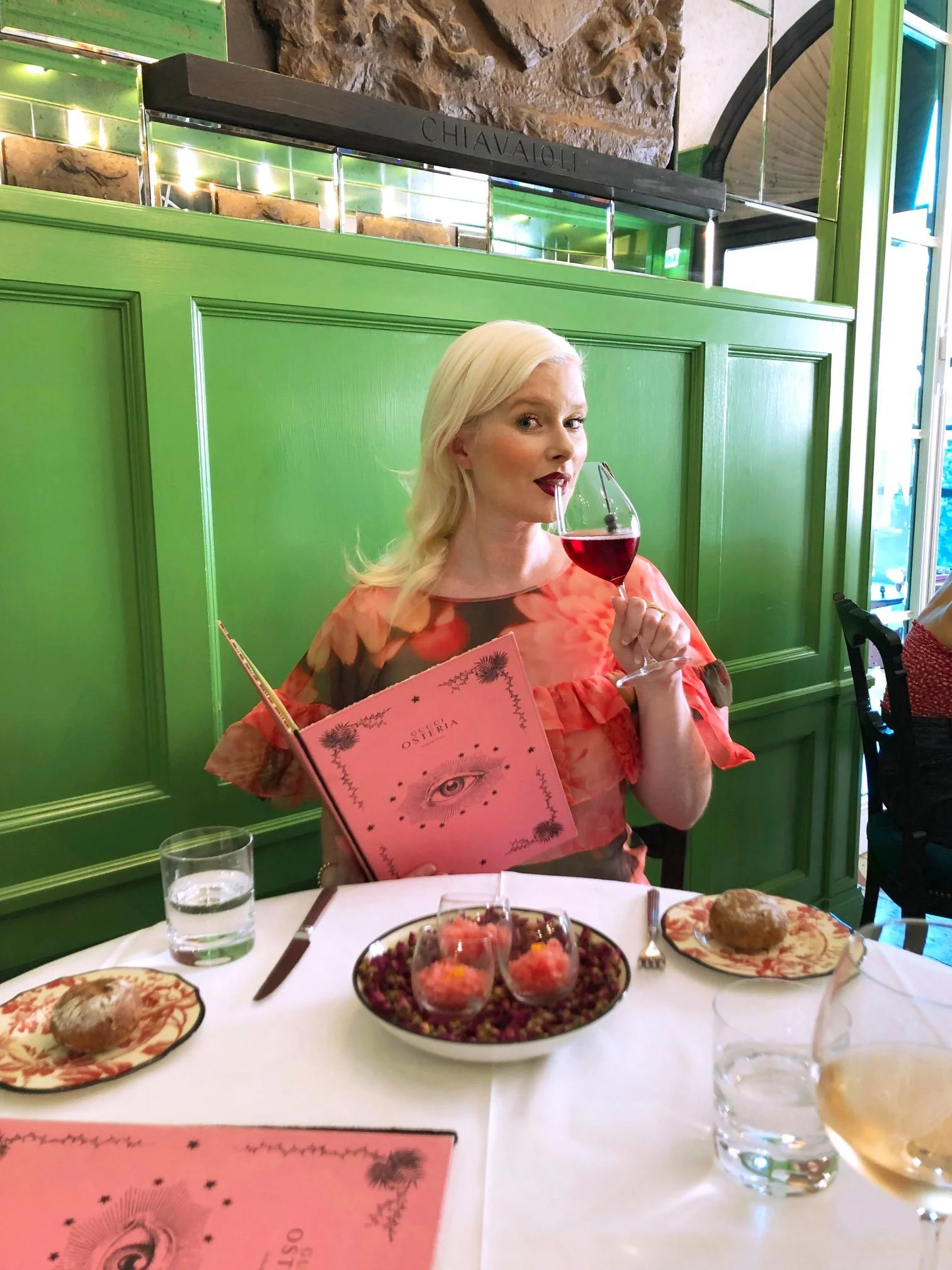 Kate Catalinac, creative director and advertising professional, in an official portfolio headshot at restaurant.