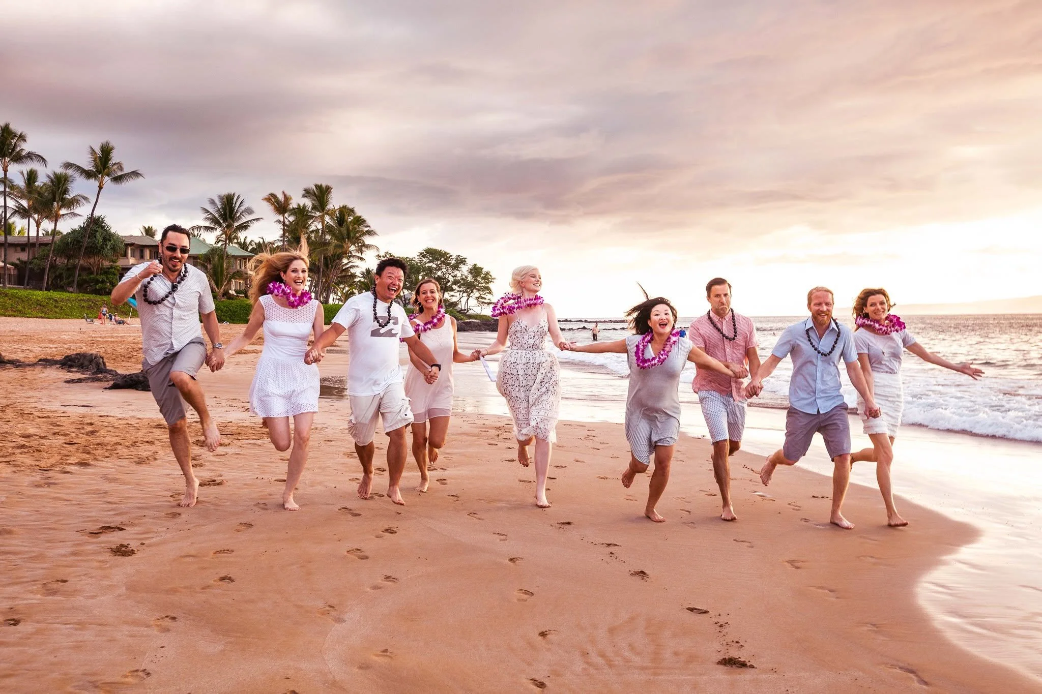 Executive portrait of advertising industry creative director Kate Catalinac running down beach with friends.