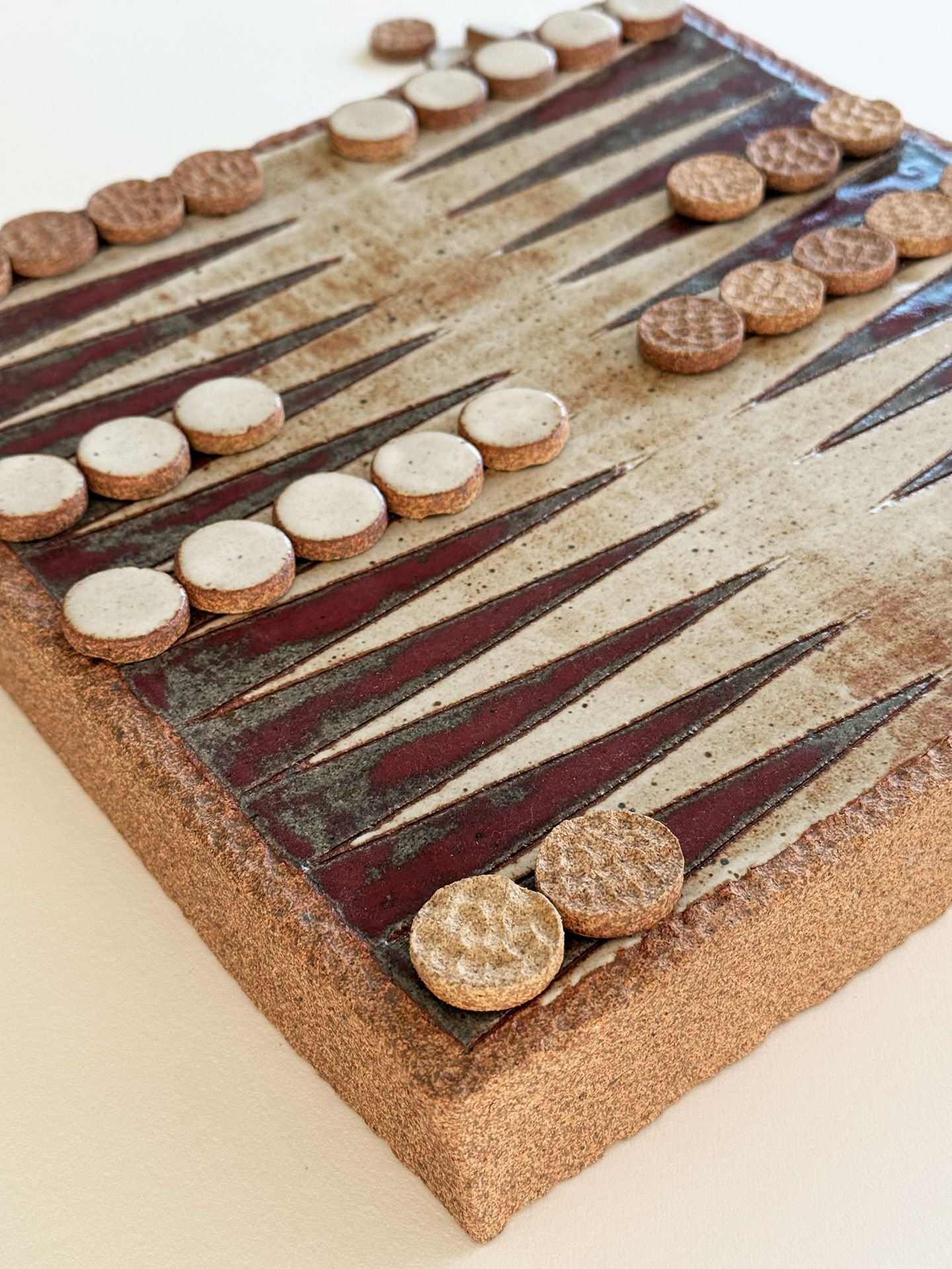 A close-up view of a backgammon game board with checkers and dice.